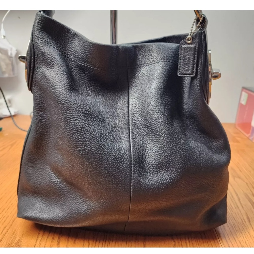 Stylish black Coach Penelope Hobo Leather handbag with silver hardware.